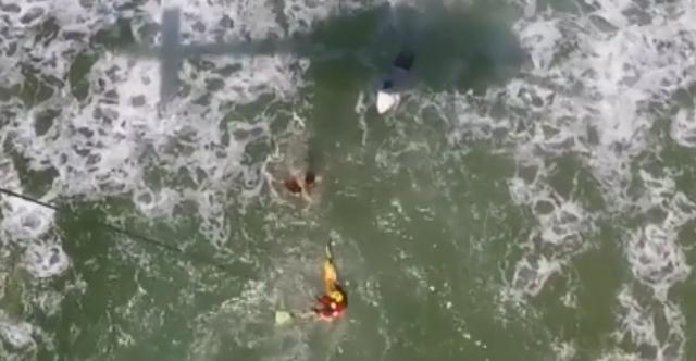 Swimmers Caught in Rip Hoisted to Safety by Rescue Helicopter. Credit — Westpac Lifesaver Rescue Helicopter Service Queensland via Storyful