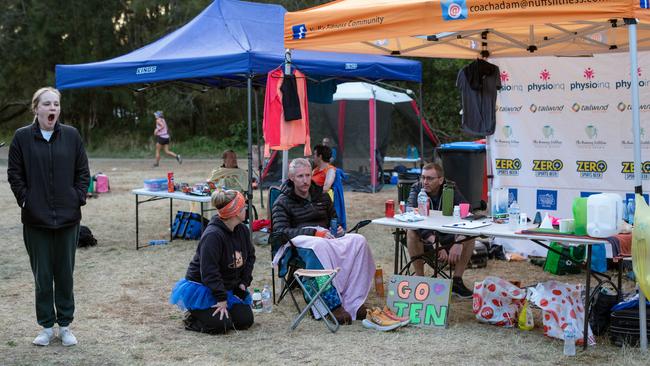 Competitors and supporters wait at tented tables set up around the finishing line. Picture: Marilia Ogayar