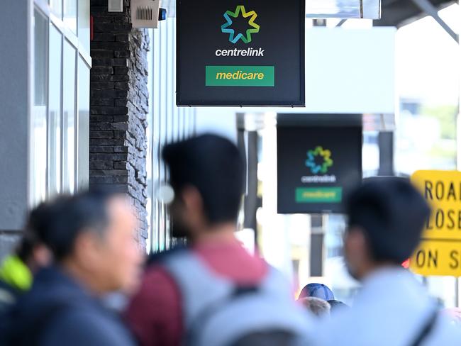 MELBOURNE, AUSTRALIA - MARCH 24: Peopler queue to enter Centrelink on March 24, 2020 in Melbourne, Australia. Non-essential travel has been banned in a bid to stop the spread of COVID-19 in Australia while venues such as bars, clubs, nightclubs, cinemas, gyms and restaurants, along with anywhere people remain static are now closed. Schools are currently open but parents have the option to keep children at home if they wish. There are now 1887 confirmed cases of COVID-19 in Australia and the death toll now stands at eight. (Photo by Quinn Rooney/Getty Images)