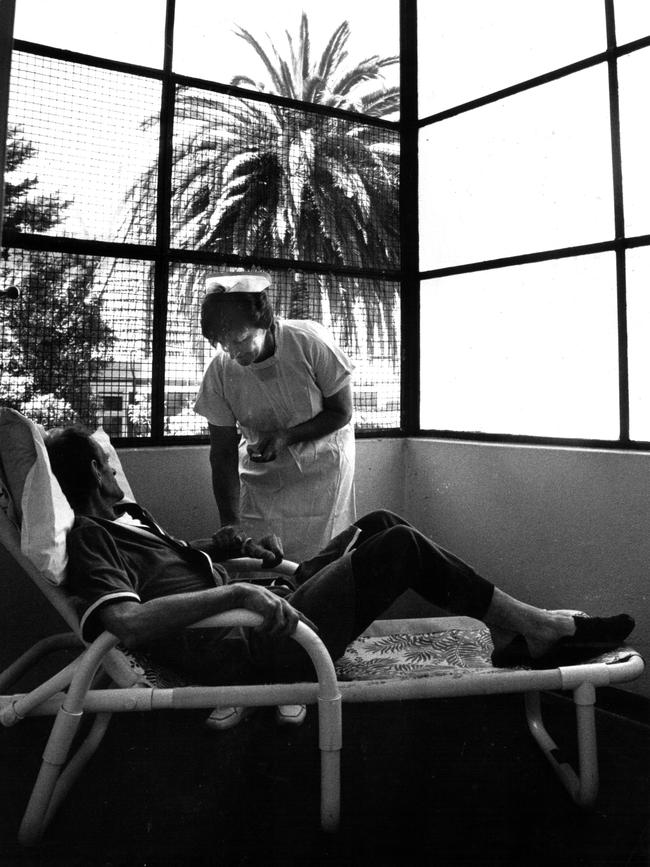 Nurse Mary Hicks with an AIDS patient in Sydney’s Fairfield Hospital in 1987. Picture: Herald Sun