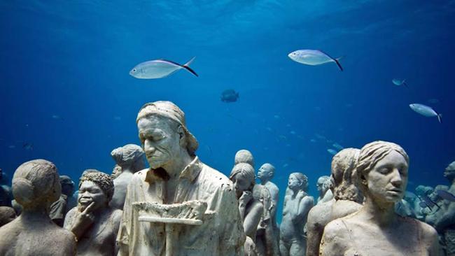 Statues from the deep sea underwater cement sculpture artwork 'The Silent Evolution' by sculptor Jason de deCaires Taylor off the coast of Cancun, Mexico.