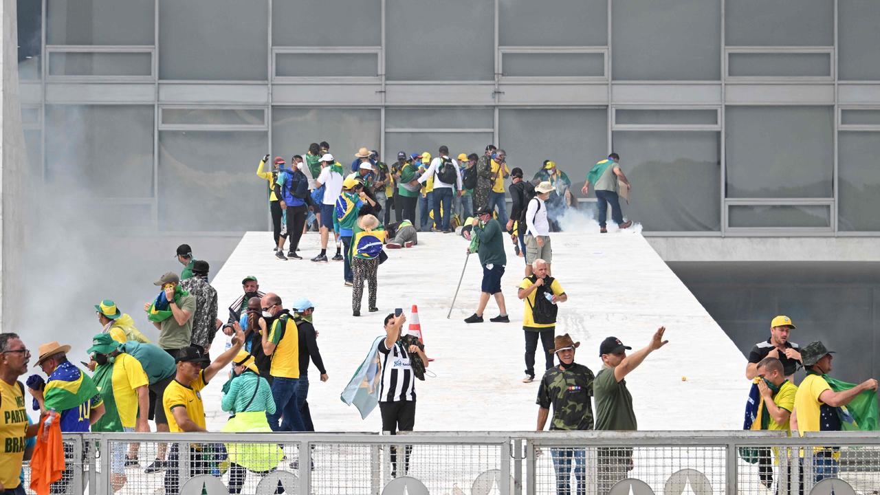 Supporters of Brazilian former President Jair Bolsonaro clash with the police during a demonstration outside the Planalto Palace in Brasilia. Picture: AFP.