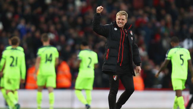 Eddie Howe manager of AFC Bournemouth celebrates victory as Liverpool players look dejected