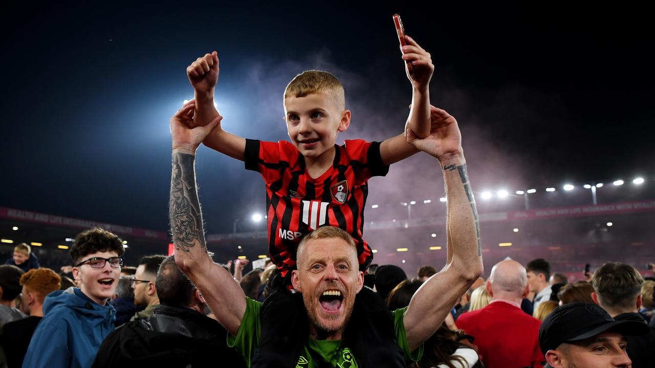 AFC Bournemouth fans celebrate on the pitch after their side’s victory. (Photo by Mike Hewitt/Getty Images)