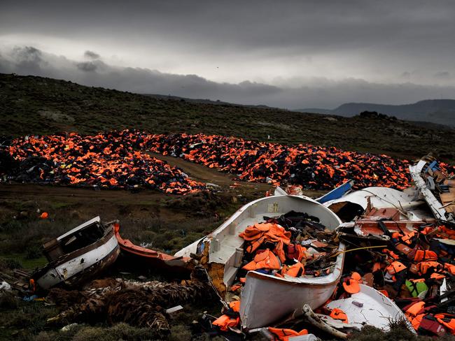 Wrecked boats and thousands of life jackets used by refugees and migrants during their journey across the Aegean sea lie in a dump in Mithimna on February 19, 2016. The EU and Turkey will hold a special summit in early March to push forward a deal to stem the migration crisis, European Council President Donald Tusk said. Picture: AFP PHOTO / ARIS MESSINIS