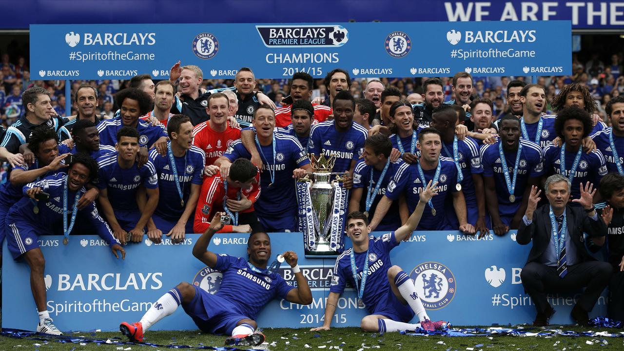 Chelsea's team players including Chelsea's Ivorian striker Didier Drogba (bottom CL) and Chelsea's Brazilian midfielder Oscar (bottom CR) and staff including Chelsea's Portuguese manager Jose Mourinho (bottom 2R) pose together during the presentation of the Premier League trophy after the English Premier League football match between Chelsea and Sunderland at Stamford Bridge in London on May 24, 2015. Chelsea were officially crowned the 2014-2015 Premier League champions. AFP PHOTO / ADRIAN DENNIS RESTRICTED TO EDITORIAL USE. NO USE WITH UNAUTHORIZED AUDIO, VIDEO, DATA, FIXTURE LISTS, CLUB/LEAGUE LOGOS OR “LIVE” SERVICES. ONLINE IN-MATCH USE LIMITED TO 45 IMAGES, NO VIDEO EMULATION. NO USE IN BETTING, GAMES OR SINGLE CLUB/LEAGUE/PLAYER PUBLICATIONS.