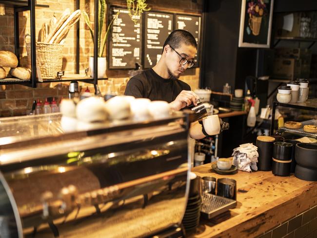 Imago manager Jack Tsai pours a coffee at the busy Elizabeth St cafe. Picture: Eddie Safarik