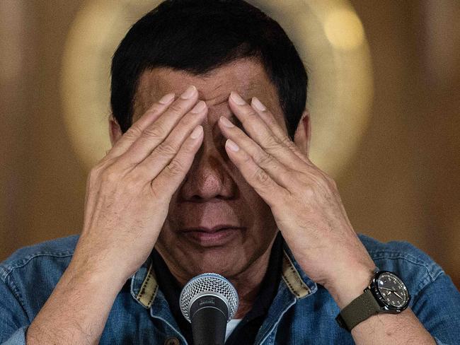 Philippine's President Rodrigo Duterte reacts as he answers a question during a press conference at the Malacanang palace in Manila on January 30, 2017. Philippine's President Rodrigo Duterte on January 30, 2017 extended his deadly drug war until the last day of his term in 2022, but conceded the police force acting as his frontline troops was 