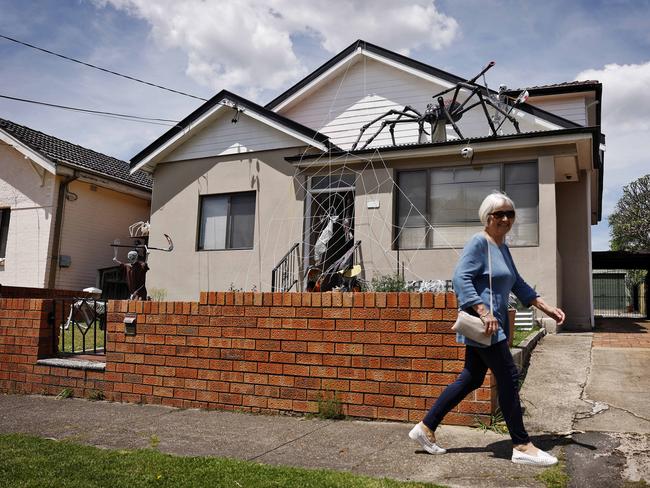 DAILY TELEGRAPH - 25/10/24 Home in Hampden Rd, Russell Lea which has a giant spider on the roof as Halloween decorations. 1 local lady has asked for it to be removed because she is scared. An unidentified woman walks past this afternoon. Picture: Sam Ruttyn