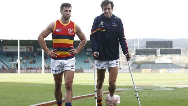 Adelaide’s Will Hamill on crutches after its narrow loss to the Hawks.