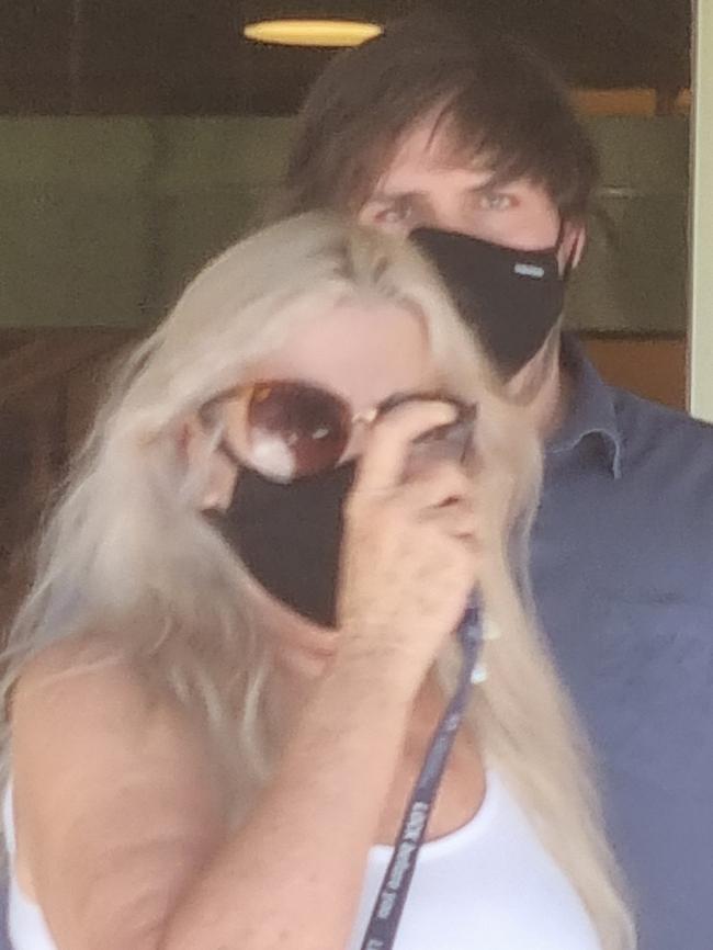 Nathan Fenwick appears to hide behind his mother after leaving court at an earlier appearance. Photo: Lucy Rutherford