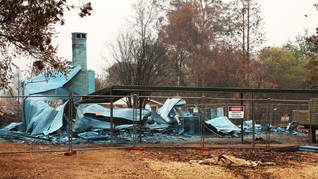 Many of the devastated properties have been sprayed with a blue bonding agent to capture stray toxic materials, such as asbestosis. Picture: Peter Lorimer.