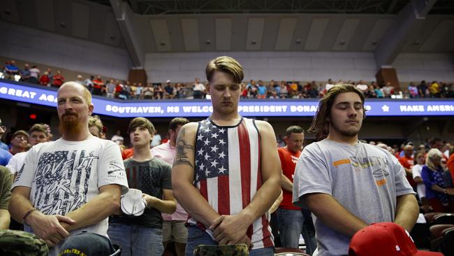 Supporters of President Donald Trump pray during the campaign rally in Southaven, Miss. Picture: AP