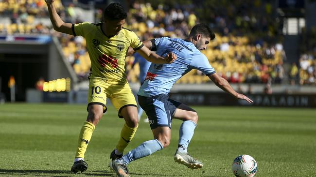Paulo Retre of Sydney FC, right, attempts to evade Ulises Davila of the Phoenix during the round-11 A-League match at Westpac Stadium in Wellington on Saturday. Picture: Getty Images
