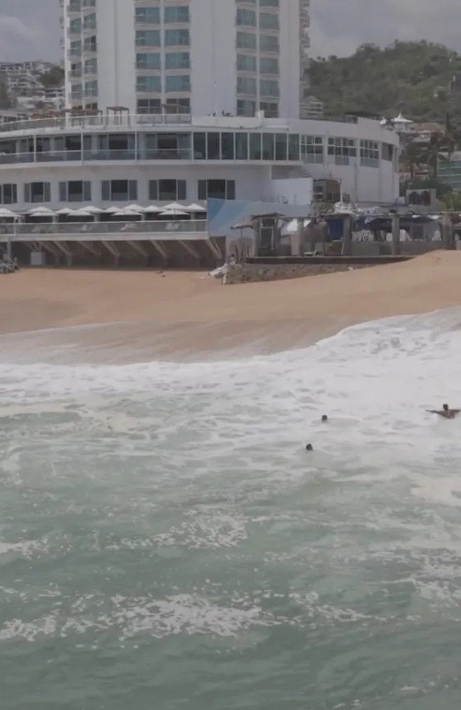 The nearly two and a half minute video shows walls of angry surf crashing onto the sandy shoreline of Icacos Beach, giving three swimmers quite the ride as they bobbed up and down. Picture: adolfokahan via Storyful