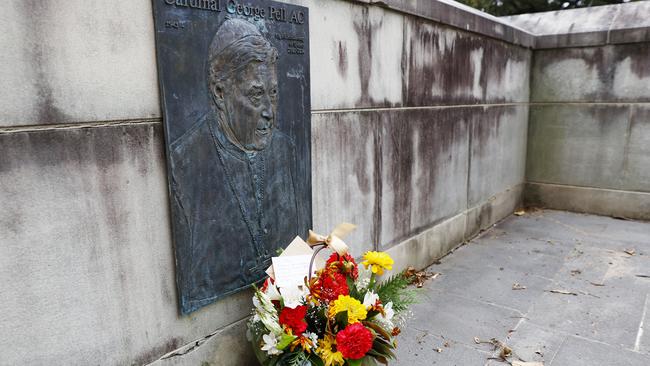 Flowers left at a plaque for George Pell after his death. Picture: Richard Dobson