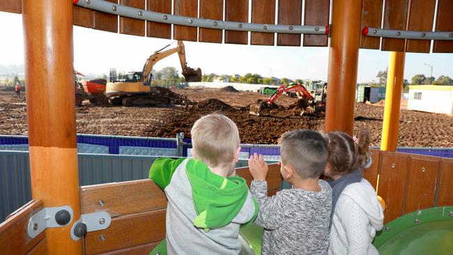 Oscar McGill, Harla Graham and Jett Gill, all three, from Little Zak’s Academy look at the location of the new Jordan Springs Primary School, which got underway recently. Picture: Angelo Velardo