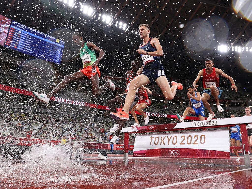 Photographers may have needed a change of clothes as they capture the Men's 3000 metres Steeplechase Final. Picture: Cameron Spencer/Getty Images