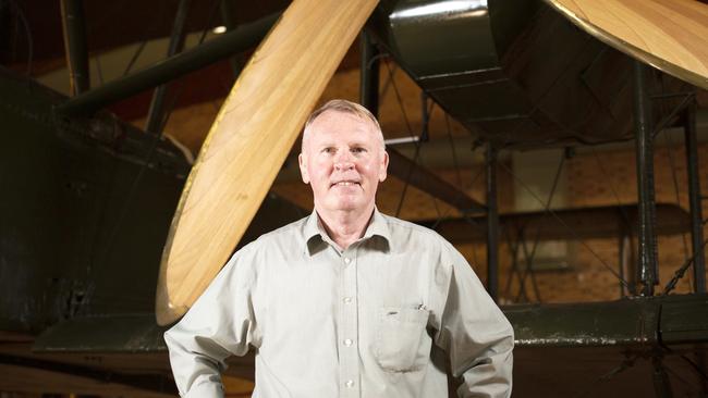 South Australian astronaut Andy Thomas in front of the restored Vickers Vimy at Adelaide Airport. Picture: AAP/Emma Brasier