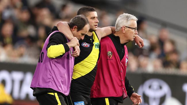 A groggy Dion Prestia leaves the field after Tom Stewart’s high bump. Picture: Michael Klein