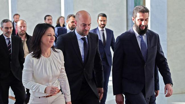 … and greets French and German foreign ministers Jean-Noel Barrot (centre) and Annalena Baerbock (left) on January 3. Picture: AFP / HO / SANA