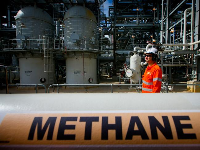 A worker walks past a gas pipe marked "Methane" at the Curtis Island liquefied natural gas (LNG) plant, a part of the Queensland Curtis Liquefied Natural Gas (QCLNG) project site operated by QGC Pty, a unit of Royal Dutch Shell Plc, in Gladstone, Australia, on Wednesday, June 15, 2016. Gas from more than 2,500 wells travels hundreds of miles by pipeline to the project, where it's chilled and pumped into 10-story-high tanks before being loaded onto massive ships. Photographer: Patrick Hamilton/Bloomberg