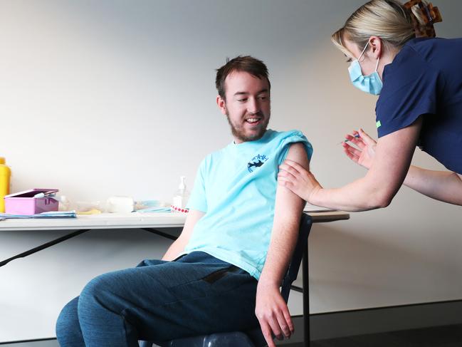 Karl Virieux with registered nurse Amanda Foster. Karl Virieux who had his first Covid vaccination at the Blundstone Arena vaccination clinic. The clinic caters to those with a disability. Picture: Nikki Davis-Jones