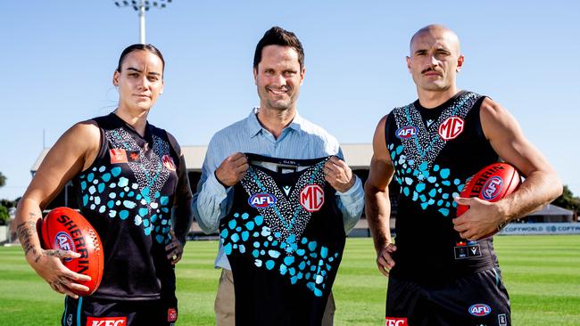 Gemma Houghton, Gavin Wanganeen and Sam Powell-Pepper in the guernsey Port Adelaide (Yartapuulti) will wear in this year’s Sir Doug Nicholls Round and AFLW Indigenous Round. Credit: Matthew Sampson