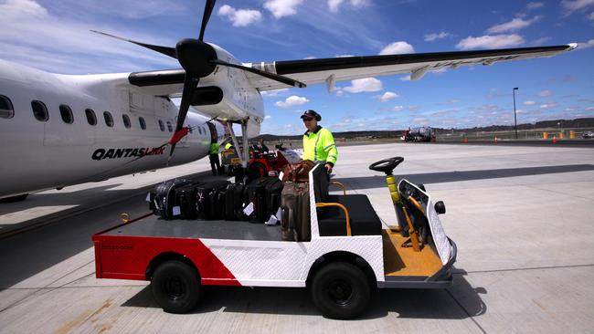 A Qantas baggage handler at work. The airline has announced plans to outsource all of its ground handling operations in a move that will see more than 2000 jobs go. Picture: Sam Mooy