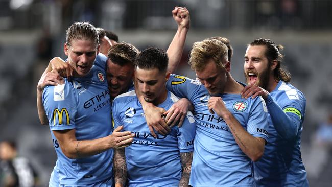 Jamie Maclaren is mobbed by his Melbourne City teammates after scoring his team’s first goal against Western United.