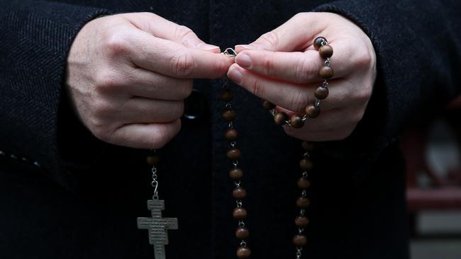 A supporter of the church is seen with his roseberry beads ahead of the George Pell appeal hearing at the Supreme Court of Victoria in June 2019 in Melbourne.