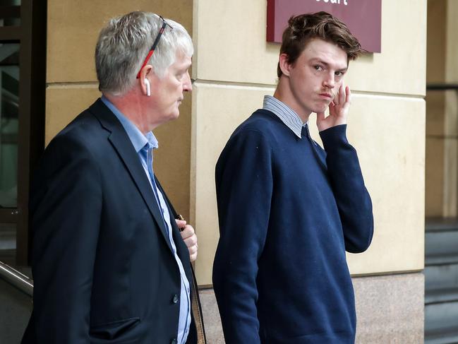 Connor Matthiasson (right) leaves the Melbourne Magistrates’ Court. Picture: Ian Currie