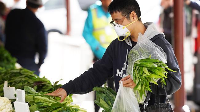 People shop for fruit and vegetables at the Queen Victoria Markets, in Melbourne, Thursday, March 26, 2020. Picture: AAP