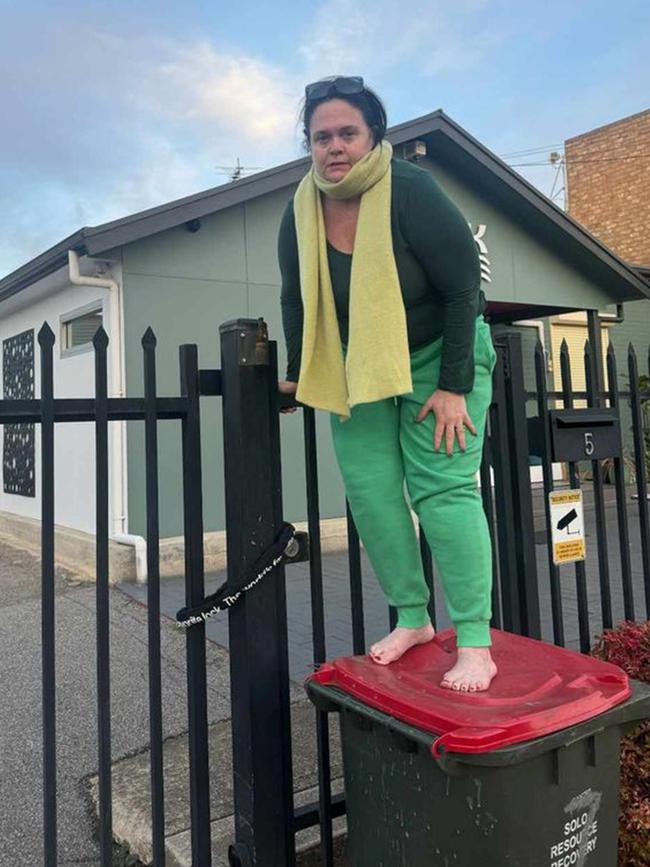 … and outside the locked gates to her Richmond business, Soak House Adelaide, in August. Picture: Supplied.