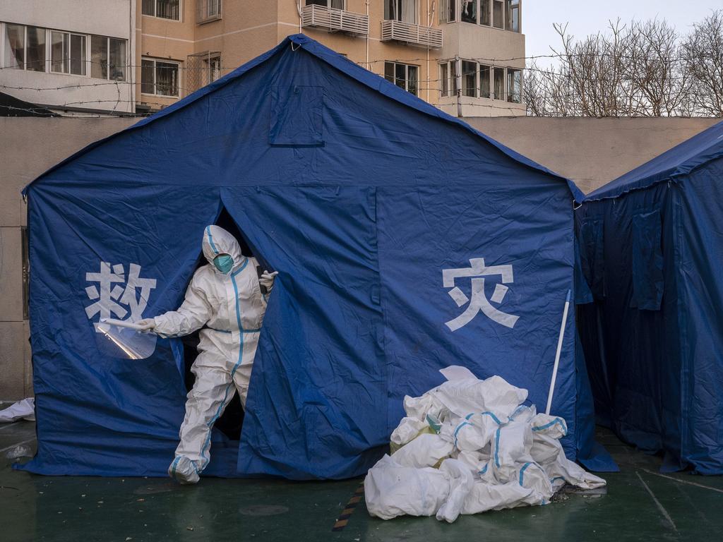 An epidemic control worker wears PPE as he leaves a tent in an area that was recently locked down due to Covid cases but now opened. Picture: Kevin Frayer/Getty Images