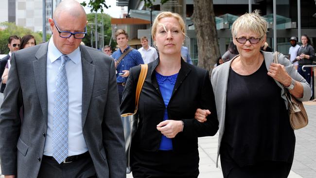 Schmoock, centre, with her lawyer Michael Woods (left) and a supporter at an earlier hearing. Mr Woods failed to have a suppression order imposed that would have kept her identity a secret.