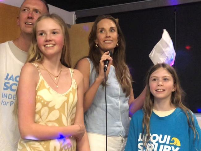 Independent candidate for the Pittwater by-election, Jacqui Scruby, celebrates her likely victory on Saturday night with her husband Michael and their two daughters at the Avalon Beach Surf Life Saving Club. Picture: Jim O'Rourke