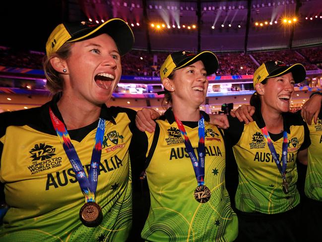 Megan Schutt, right, celebrates her team’s ICC Women's T20 World Cup final win over India with Beth Mooney, left and Rachael Haynes, middle. Picture: MARK STEWART