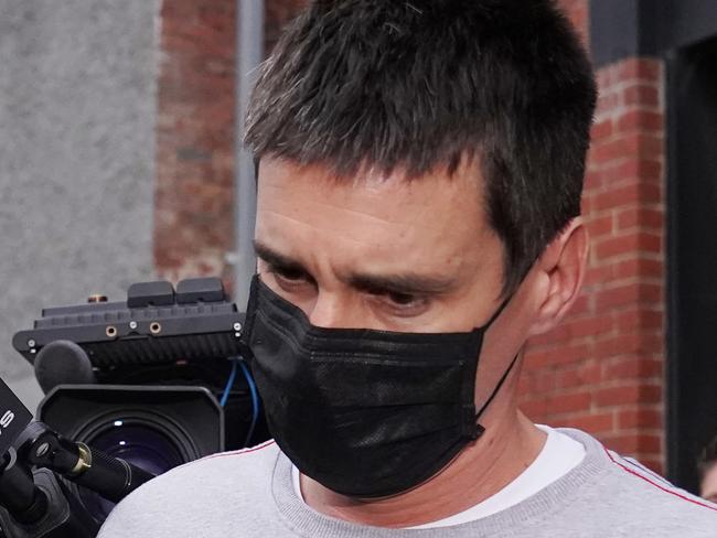 Richard Pusey, the driver of a Porsche who allegedly fled the scene of a truck crash on Melbourne's Eastern Freeway which killed four police officers, is taken away from his Fitzroy property by police in Melbourne, Thursday, April 23, 2020. (AAP Image/Michael Dodge) NO ARCHIVING