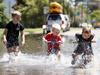 DAILY TELEGRAPH NOVEMBER 17, 2021. From left Cheyse Hoy, 6, brother Jaxon Hoy, 4, and friend Mack Acheson, 4, playing in the flood waters of the Lachlan River at the Forbes Iron Bridge Picture: Jonathan Ng