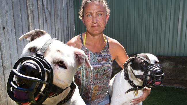 Shelly Forsman with her two American Staffordshire terriers, Harry and Sid, wearing their muzzles. Picture Glenn Hampson