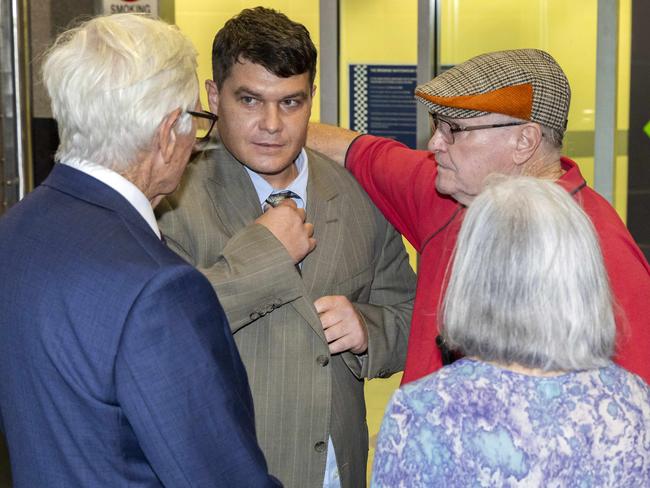 Scott Rush with parents Lee and Christine Rush (right) outside Brisbane watch-house on Monday. Picture: Richard Walker