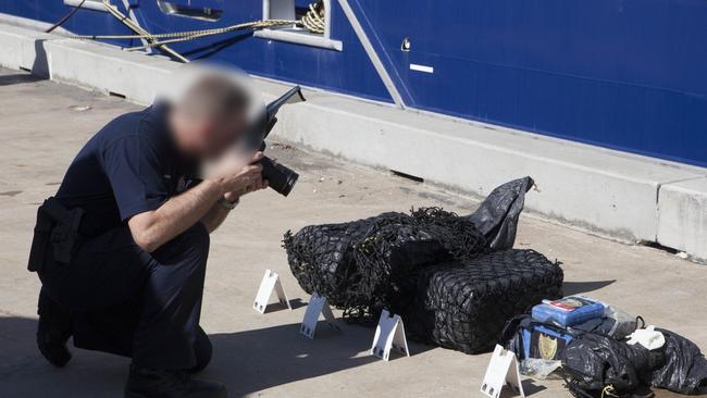 An Australian Federal Police photographer takes pictures of the packages that were retrieved from the ocean after Dru Baggaley allegedly threw them overboard off the coast of northern NSW in July 2018.