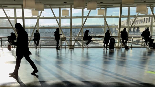 Passengers stay 1m away from each other as they wait to take an early train at Rome's Termini railway station. Picture: AFP