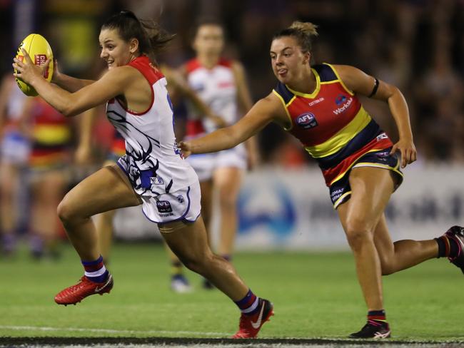 Ebony Marinoff chases after then Bulldogs player Monique Conti last season. Conti now players for expansion club Richmond. Picture: AFL Media/Getty Images