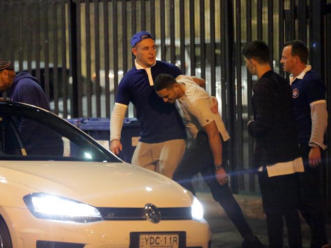 A Bulldogs player being carried by his friends out of the Harbour View Hotel at The Rocks. Picture: Christian Gilles