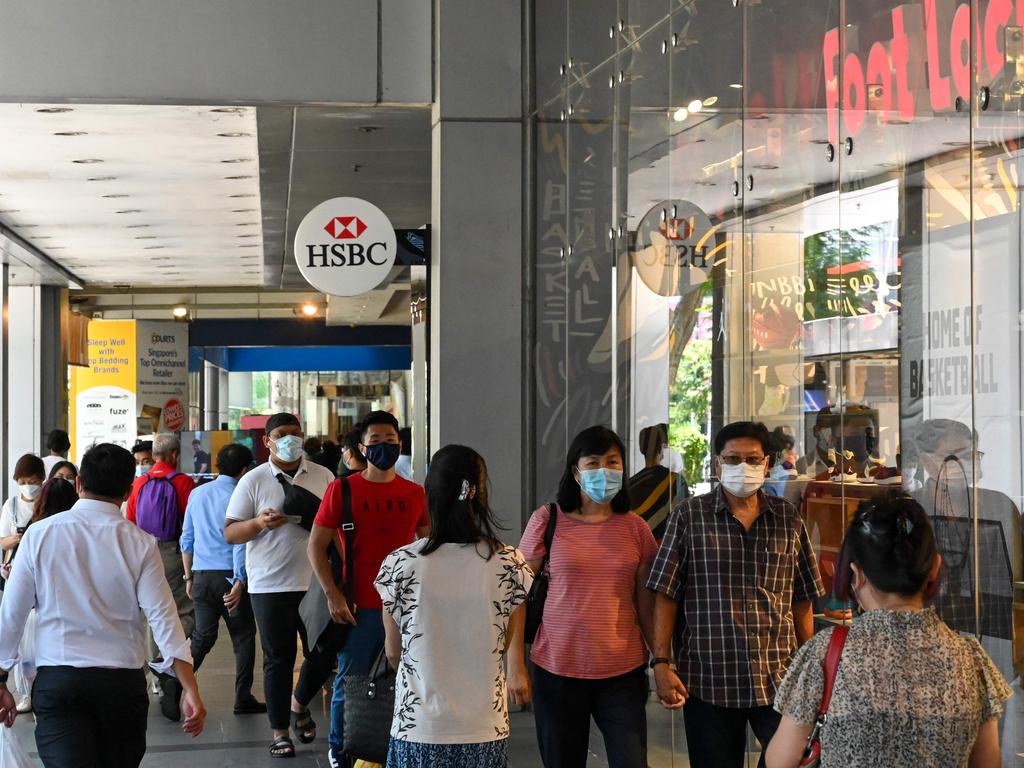 People walk past a shopping mall along Orchard Road in Singapore, where a new model with dealing with Covid is being used. Picture: AFP