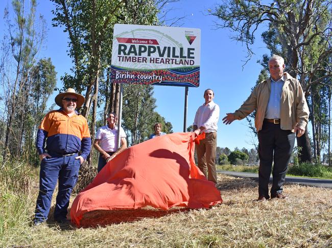 Bold new signs for Rappville.Pictured is designer Ian Thompson, Richmond Valley mayor Robert Mustow, Rappville resident Barbara Collins, Lismore City Council mayor Isaac Smith and Pastor Peter Boughey from Toys Change Lives where indigenous artist Lenny Hickling works. (he painted the painting at the bottom of the sign.)