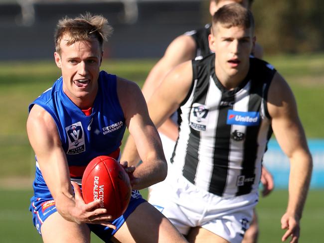 Will Hayes fires off a handball in the VFL.