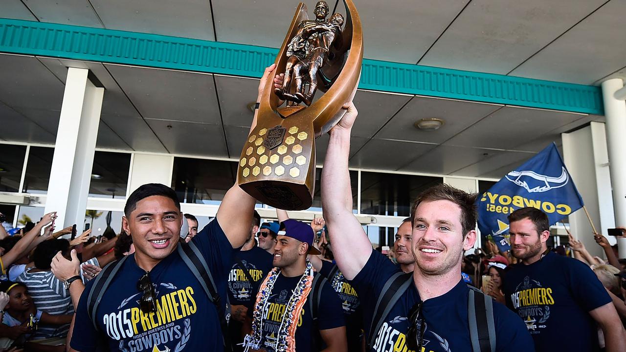 ason Taumalolo and Michael Morgan of of the Cowboys hold the NRL trophy aloft after arriving back at the Townsville airport before heading out to the North Queensland Cowboys NRL Grand Final fan day at 1300 Smiles Stadium on October 5, 2015 in Townsville, Australia. (Photo by Ian Hitchcock/Getty Images)